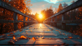 A wooden bridge with leaves on it and a sun shining on it