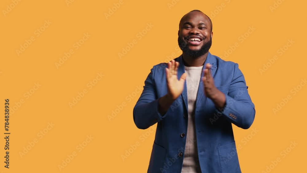 Approving smiling african american man happily clapping hands, satisfied with accomplishments. BIPOC person cheering, doing praising gesture, isolated over studio background, camera B Approving smiling african american man happily clapping hands, satisfied with accomplishments. BIPOC person cheering, doing praising gesture, isolated over studio background, camera B