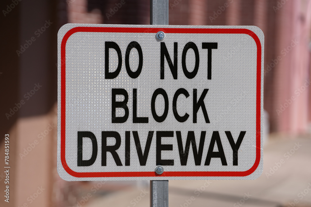 do not block driveway street sign downtown on a sunny day do not block driveway street sign downtown on a sunny day