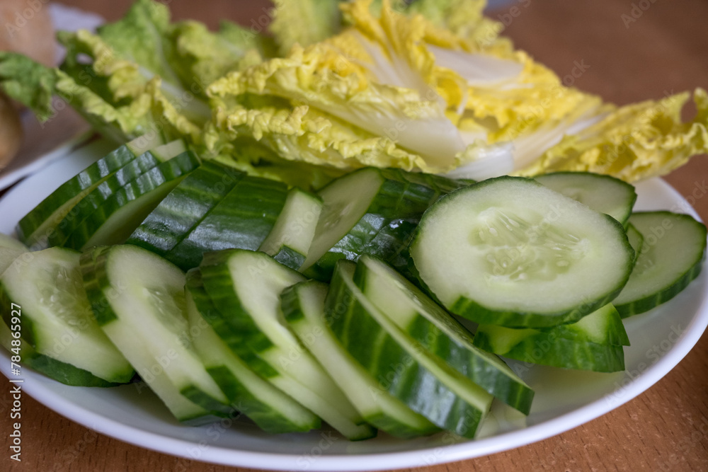 The concept of proper nutrition and a healthy lifestyle.Cucumbers are cut into slices. The concept of proper nutrition and a healthy lifestyle.Cucumbers are cut into slices.