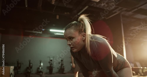 Sportswoman taking break after intense workout at gym