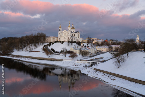 Assumption Mountain, the Holy Spirit Monastery and the Holy Assumption Cathedral on the banks of the Western Dvina and Vitba rivers on a sunny winter evening, Vitebsk, Belarus photo