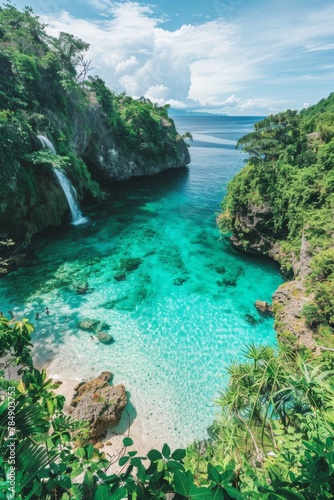 A panoramic view of a secluded cove with crystal-clear turquoise water  fringed by lush greenery and a hidden waterfall