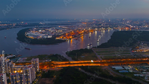 Aerial view from drone of Ho Chi Minh city port, canal system for traffic waterway on Saigon river, crane and container at riverside harbor, logistic for export, import industrial with cheap expense