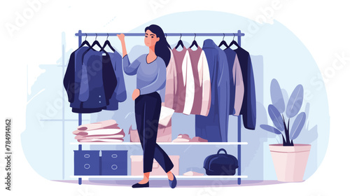 Woman standing at open wardrobe and choosing clothe