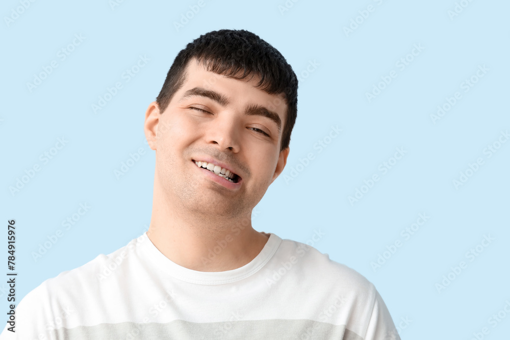 Young man on blue background, closeup. National Cerebral Palsy Awareness Month - obrazy, fototapety, plakaty 