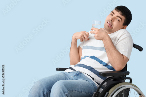 Young man with glass of wat...
