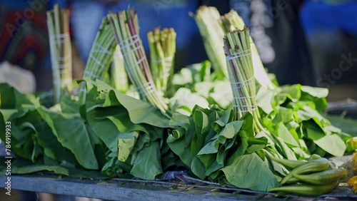 Bunches of young taro leaves for sale at the market.