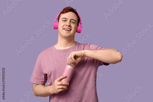 Young man in headphones ope...