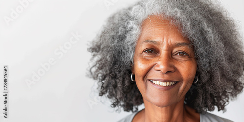 Elderly black African American woman smiling with copy space. Happiness, dark skin tone, white teeth, natural beauty, graceful aging concept