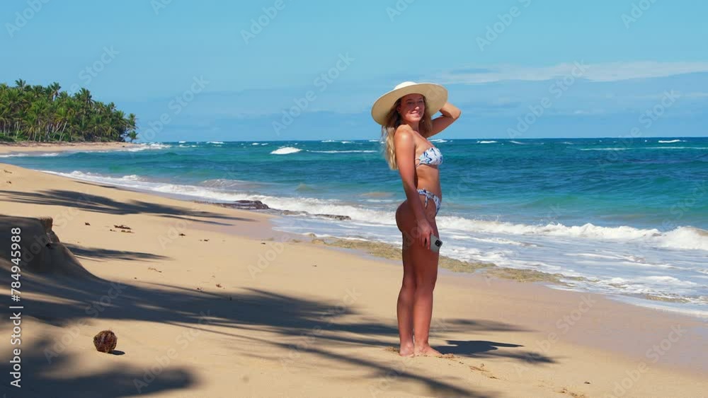 A Bikini Goddess is sunbathing on tropical beach looking around the beach. A Bikini Goddess is sunbathing on tropical beach looking around the beach.