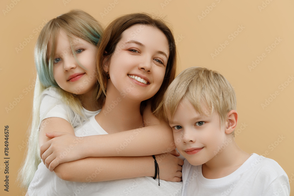 Happy people. Mother's Day. Mother hugging her cute children . Happy loving family. Mother and her children girl and boy playing and hugging. Brother and sister. Happy people. Mother's Day. Mother hugging her cute children . Happy loving family. Mother and her children girl and boy playing and hugging. Brother and sister.