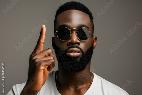 handsome african american man in sunglasses showing middle finger isolated on grey photo