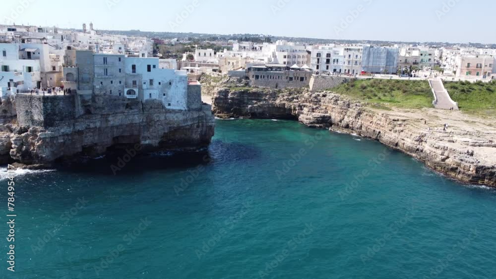 Aerial drone panorama of Polignano a mare, a beautiful city in Puglia, italy, on a sunny day. Visible beach coming to the sea and the old town next to it. Aerial drone panorama of Polignano a mare, a beautiful city in Puglia, italy, on a sunny day. Visible beach coming to the sea and the old town next to it.