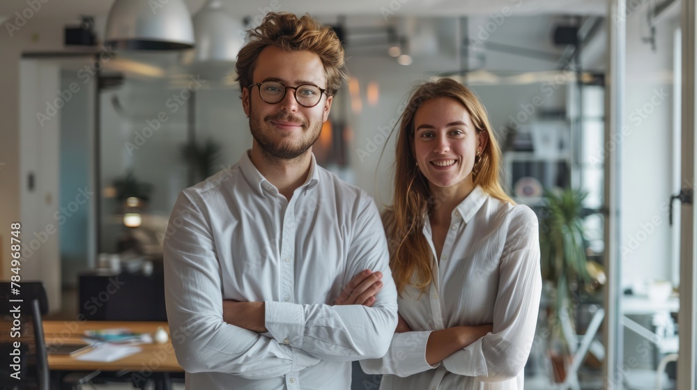 Two businessmen standing together in the office Confident male and female professionals in open plan workplace Two businessmen standing together in the office Confident male and female professionals in open plan workplace