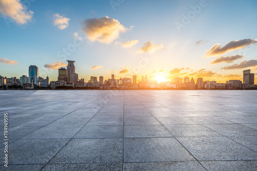 City square floor and Shanghai Bund skyline with modern buildings at sunset photo