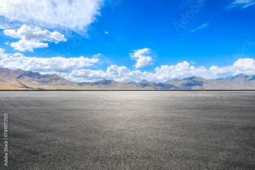 Asphalt road square and mountains with sky clouds on a sunny day