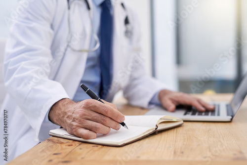 Doctor, writing and hands of notes with computer and medical research for muscular dystrophy in office. Person, tech and report information in notebook with medical study of healthcare worker photo