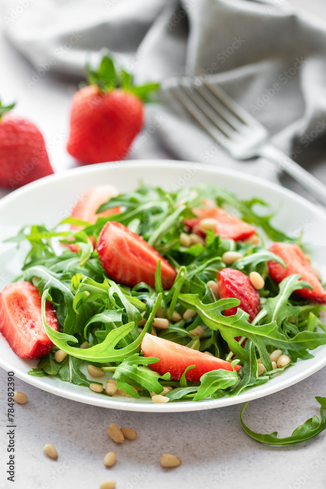 Fresh Strawberry Arugula Salad With Pine Nuts Served on a Bright Day