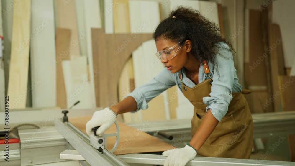 Side view carpenter or woodworker or charpentier woman bring wooden planks and set to fit with the other tools to prepare for wood work in workplace.