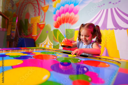 Young Girl Engaging in Colorful Board Game Fun at a Vibrant Playroom