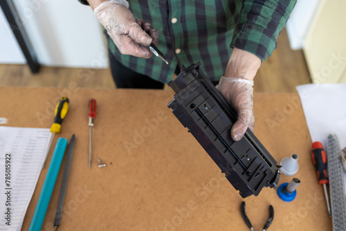 Toner replacements in printer cartridge. Printer service concept. Disassembly of the printer cartridge for its maintenance and refilling with toner. 