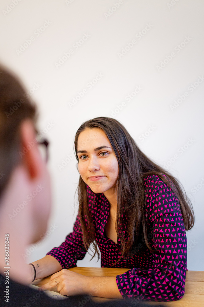 Aboriginal woman sitting in a meeting with a man in an office Aboriginal woman sitting in a meeting with a man in an office