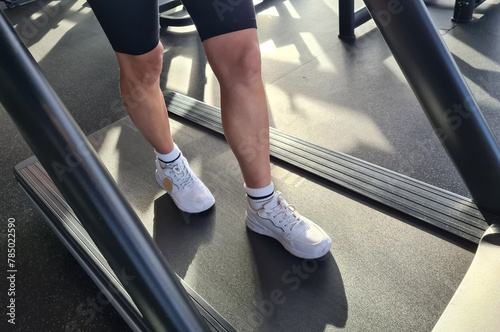 Woman Walking on Treadmill in Gym