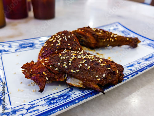 Grilled chicken with spicy sauce served in Chinese style with sesame seed.