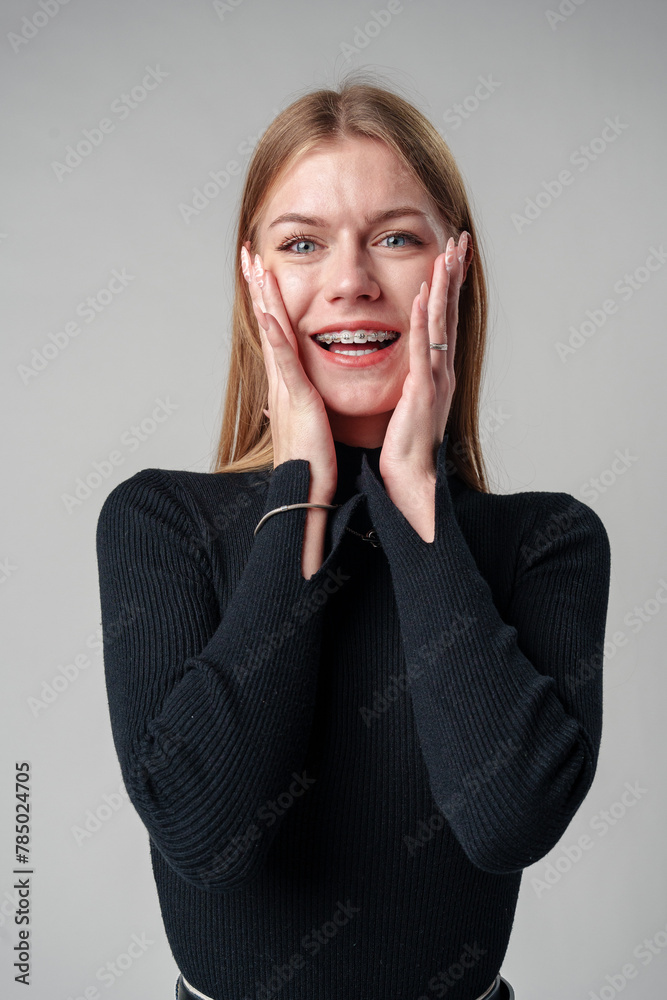 Smiling Woman in Black Top against gray background Smiling Woman in Black Top against gray background