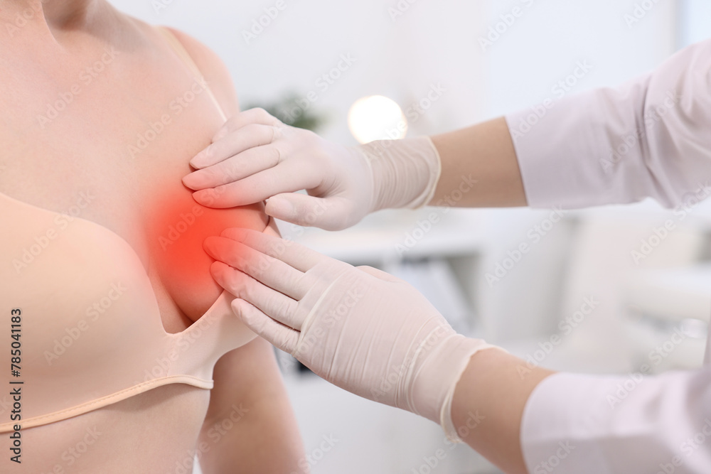 Fototapeta premium Mammologist checking woman's breast in hospital, closeup