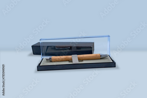 A very expensive looking wooden pen in a glass box
