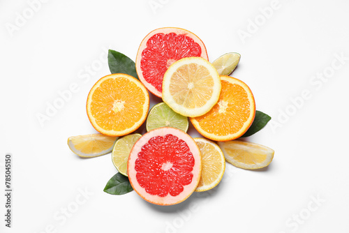 Different cut citrus fruits and leaves on white table  flat lay