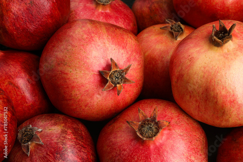 Many fresh ripe pomegranates as background, closeup
