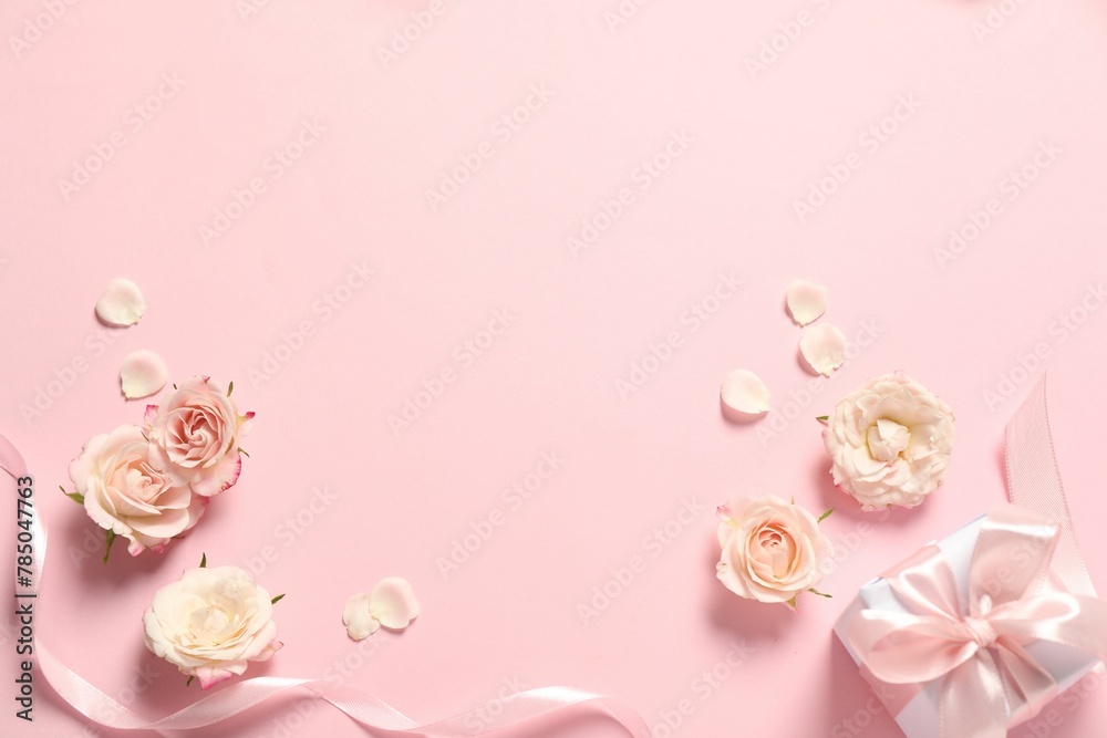 Happy Mother's Day. Beautiful flowers, gift box and ribbon on pink background, flat lay. Space for text