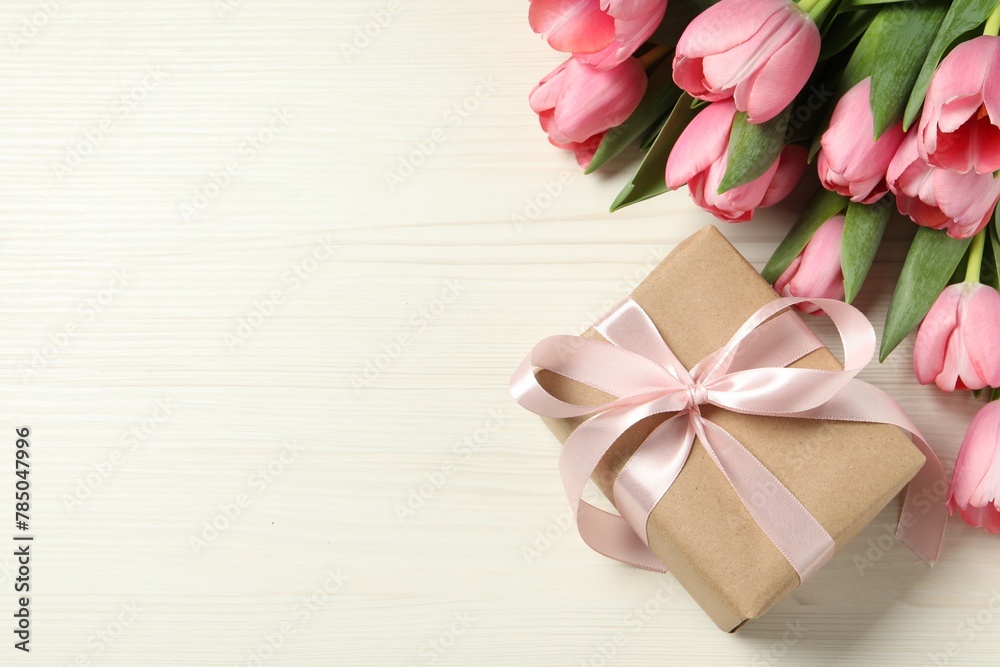 Happy Mother's Day. Beautiful pink tulips and gift box on white wooden table, flat lay. Space for text Happy Mother's Day. Beautiful pink tulips and gift box on white wooden table, flat lay. Space for text