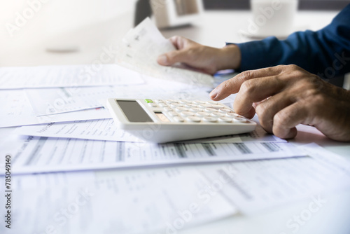 Close-up shot. asian men hand using calculator to calculate expenses and tax to recive tax reduction for personal individual Income. tax return concept for individual person