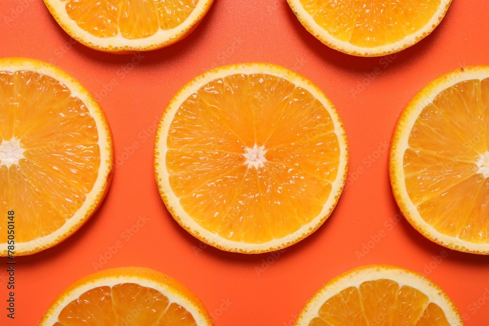 Slices of juicy orange on terracotta background, flat lay Slices of juicy orange on terracotta background, flat lay
