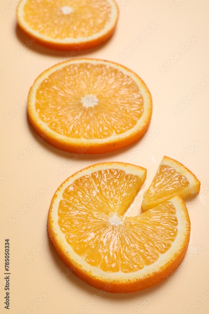 Slices of juicy orange on beige background, closeup Slices of juicy orange on beige background, closeup