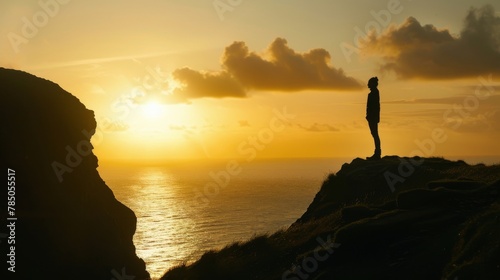 Solitude: Silhouette of Person on Cliff at Sunset
