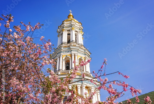Pink sakura blossom in the front of the bell tower of Kyiv Pechersk Lavra
