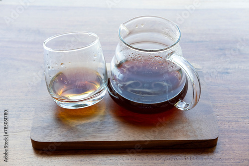 Pour over hot coffee serve with glass on wooden plate