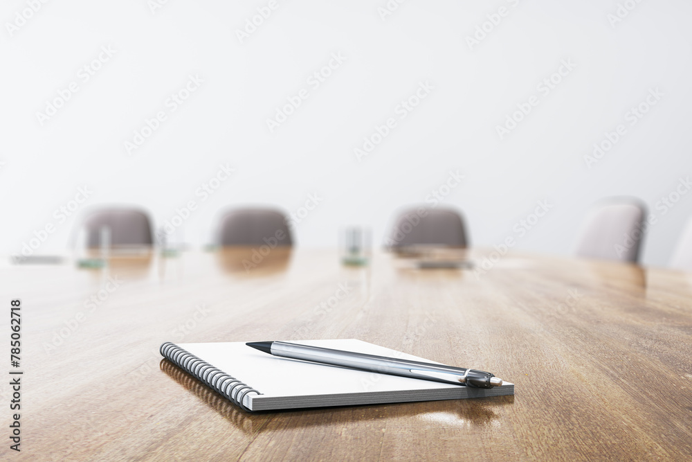 Close up of wooden conference table with empty notepad and pen for morning notes. Blurry chairs in the backdrop. Business meeting concept. Mock up place, 3D Rendering. Close up of wooden conference table with empty notepad and pen for morning notes. Blurry chairs in the backdrop. Business meeting concept. Mock up place, 3D Rendering.