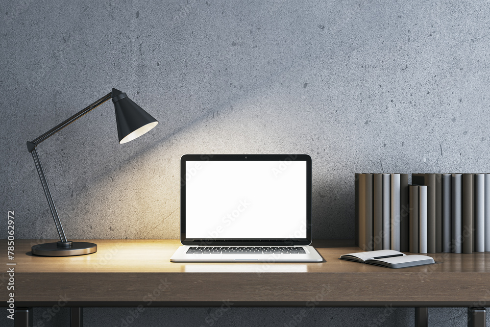 Modern concrete workplace with lamp, books and white mock up laptop. Workspace close up. 3D Rendering. Modern concrete workplace with lamp, books and white mock up laptop. Workspace close up. 3D Rendering.
