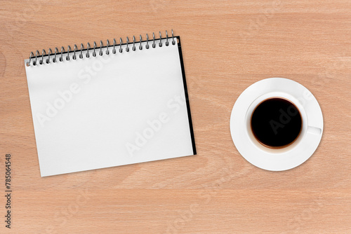 Coffee and notebook on the wood background