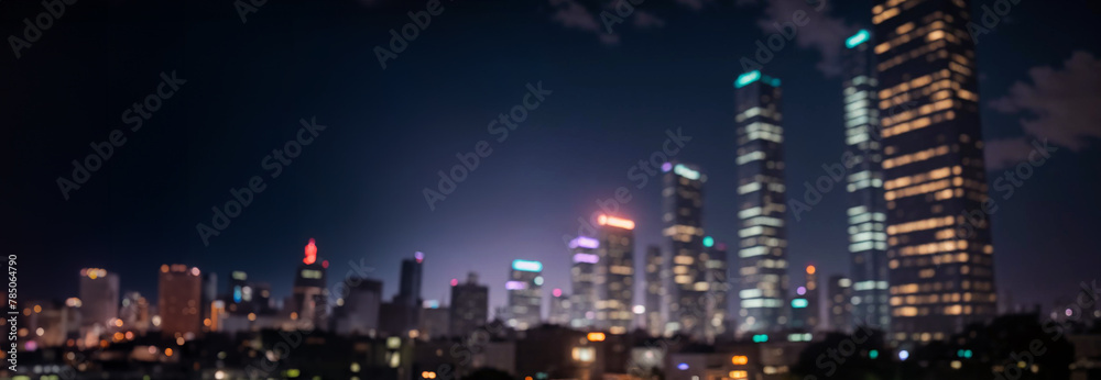 Obraz premium Abstract night lights of a modern futuristic cityscape. Defocused image, view of a dark modern urban skyline in the evening glow with many tall buildings, towers, skyscrapers with glowing windows.
