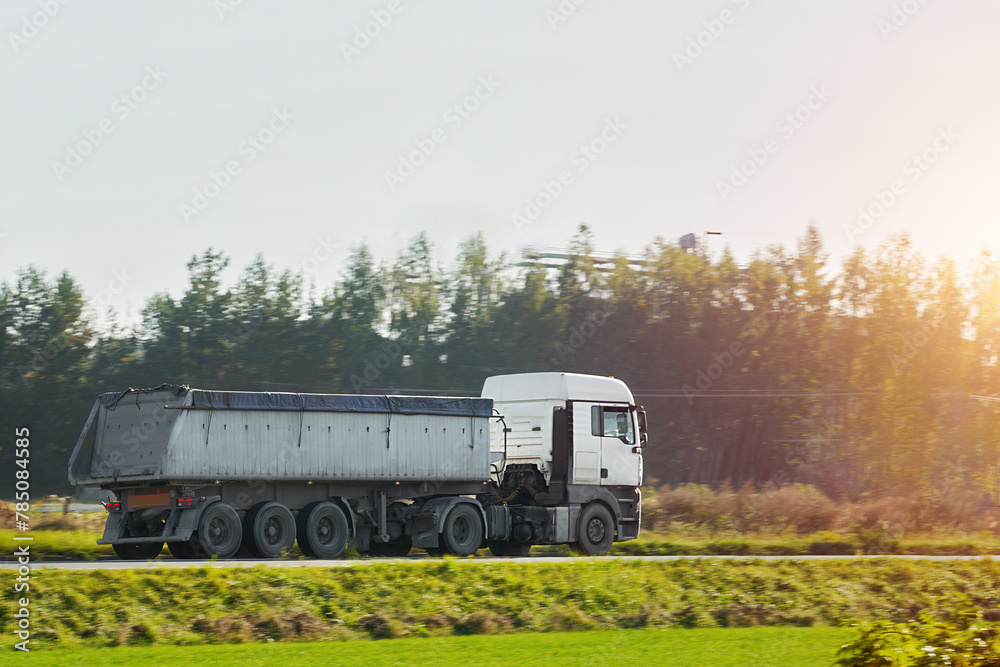 Hauler Truck on Highway Delivering Construction Supplies in a Dump Trailer