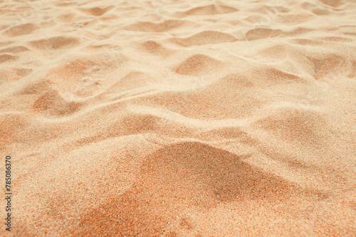 Beach sand background, close up, Low angle view of brown sandy surface in tropical resort. Vacation and summer holiday concept. © Bits and Splits
