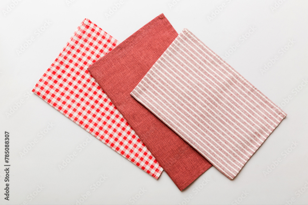 top view with red empty kitchen napkin isolated on table background. Folded cloth for mockup with copy space, Flat lay. Minimal style top view with red empty kitchen napkin isolated on table background. Folded cloth for mockup with copy space, Flat lay. Minimal style