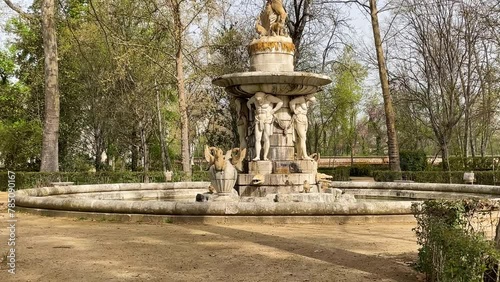 We see in the Jardin de el Principe an impressive fountain with human sculptures holding a main character Narcissus on a round pedestal from there, the Fountain of Narcissus from the 18th century. photo